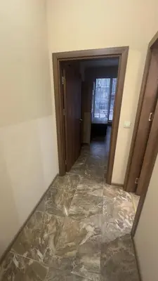 a hallway with a marble floor in a room at Studio paradise in Varna City
