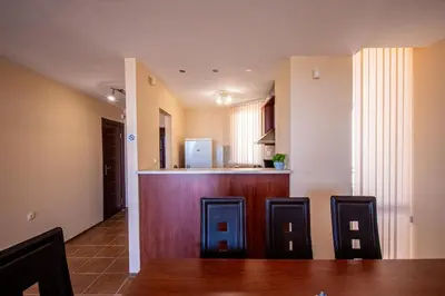a kitchen and dining room with a bar at Villa Belissima in Sveti Vlas