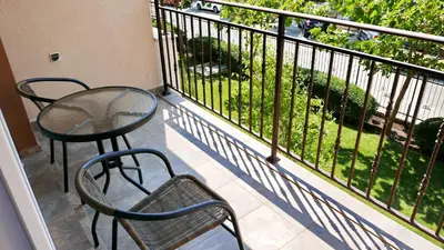 a balcony with a table and chairs on a balcony at Oxygen Apartments in Sveti Vlas