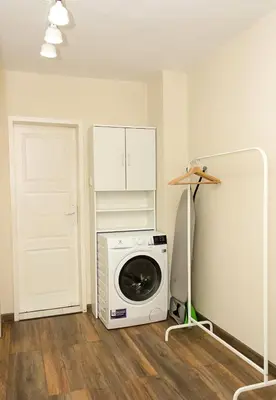 a washer and dryer in a room with a door at Cozy & Functional by the Opera in Varna City