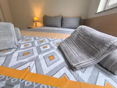 a bedroom with two beds with towels on them at Lazur Sea Garden 2 in Burgas City