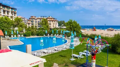 a swimming pool with chairs and umbrellas in a resort at Hotel Oasis Del Mare in Lozenets