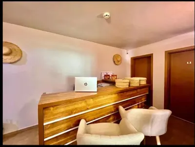 an office with a desk with two chairs and a laptop at Къща за гости Беглик таш 3 in Primorsko