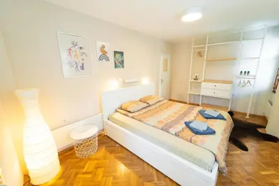 a bedroom with a bed and a lamp in it at Soleado in Burgas City