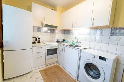 a kitchen with a washing machine and a washer at Soleado in Burgas City