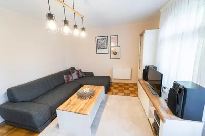 a living room with a couch and a tv at Soleado in Burgas City