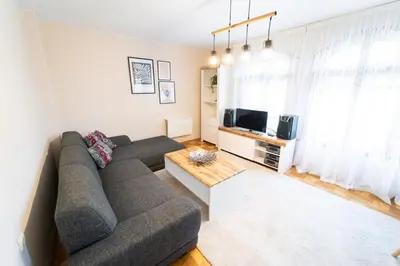 a living room with a couch and a tv at Soleado in Burgas City