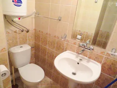 a bathroom with a toilet and a sink at Апартамент Съни Хаус - Sunny House Apartment in Byala