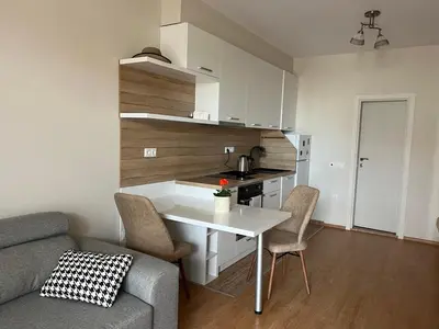 a kitchen with a table and chairs in a living room at Vineyard Spa Resort Aheloy - Muscat-6 Studio in Kableshkovo