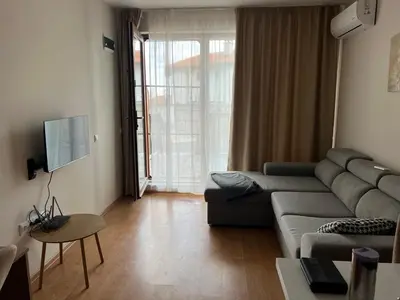 a living room with a couch and a tv at Vineyard Spa Resort Aheloy - Muscat-6 Studio in Kableshkovo
