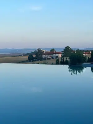 a view of a lake with a house in the background at Vineyard Spa Resort Aheloy - Muscat-6 Studio in Kableshkovo