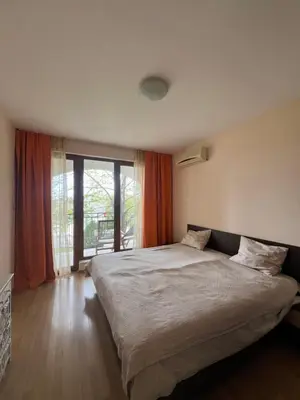 a bedroom with a large bed and a large window at Sea Side Apartment with Balcony in Sveti Vlas