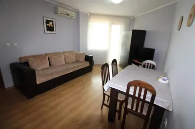 a living room with a table and a couch at Amadeus 5 - Menada Apartments in Sunny Beach