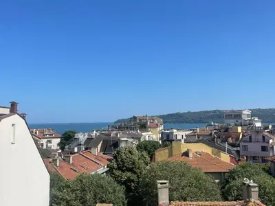 a view of a city with houses and the water at Roman Thermae, steps from the sea with free parking in Varna City
