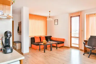 a living room with a couch and a table at Roman Thermae, steps from the sea with free parking in Varna City