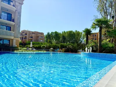 a large swimming pool in front of a building at Menada Aphrodite Green Apartments in Sunny Beach