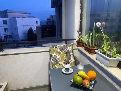 a tray of fruit on a table on a balcony at Sea Sunrise Apartment in Burgas City