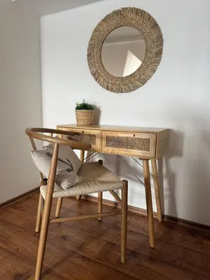 a wooden table with a mirror and a chair at Cosy Seaview apartment Budjaka in Sozopol