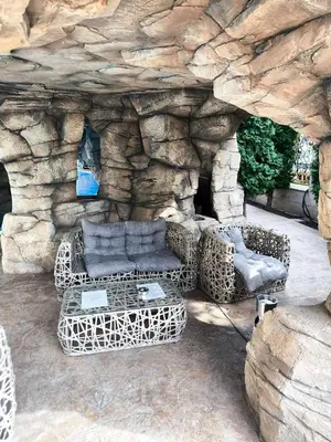 a group of couches and chairs in a stone cave at Excellent apartment on the 6th floor in Sunny Beach