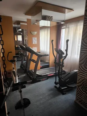 a gym with treadmills and exercise bikes in a room at Excellent apartment on the 6th floor in Sunny Beach