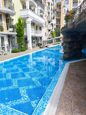 a swimming pool in a hotel with blue water at Excellent apartment on the 6th floor in Sunny Beach