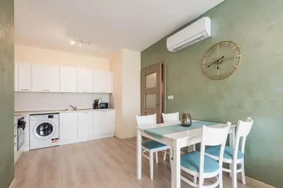 a kitchen and dining room with a table and chairs at Blue Horizon Suite in Varna City