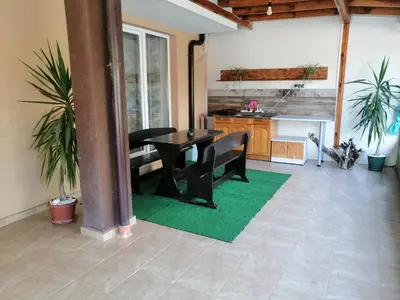 a living room with a table and a kitchen at Path ways to the Sea -Пътека към морето in Primorsko
