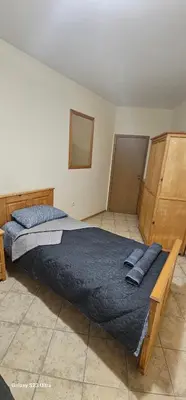 a bedroom with a large bed with blue pillows at Apartament Prestig Sity in Sunny Beach