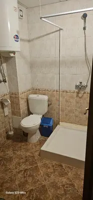 a bathroom with a toilet and a shower stall at Apartament Prestig Sity in Sunny Beach