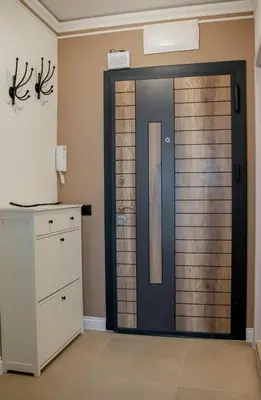 a wooden door in a room with a dresser at ВХТИ Park - Premium Apartment in Burgas City