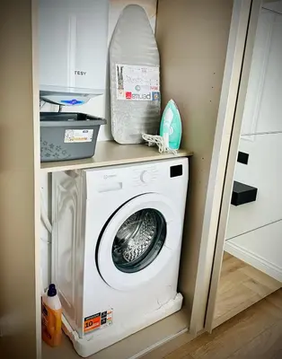 a washer and dryer on a shelf in a kitchen at ВХТИ Park - Premium Apartment in Burgas City