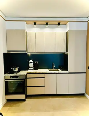 a kitchen with white cabinets and a sink at ВХТИ Park - Premium Apartment in Burgas City