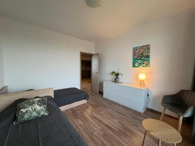 a bedroom with a bed and a desk and a chair at Family Apartment with Sea View Vineyard Spa Resort Aheloy in Aheloy