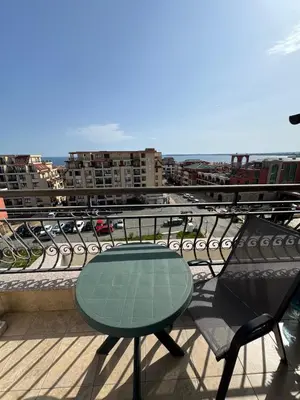 a table and chairs sitting on a balcony at Sea View Apartment Sveti Vlas 1 Bedroom K&R in Sveti Vlas