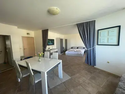 a living room with a white table and chairs at The Royal Bay Hideaway Studio in Aheloy