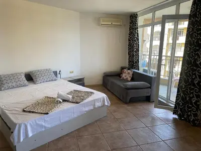 a bedroom with a bed and a couch at The Royal Bay Hideaway Studio in Aheloy