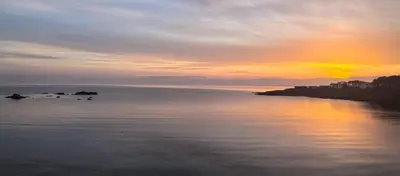 a sunset over a large body of water at AURA BEACH apartment in Burgas City