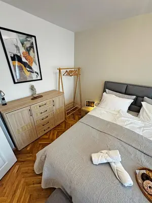a bedroom with a bed with a towel on it at AURA BEACH apartment in Burgas City