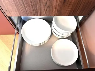 three white plates sitting on a glass shelf at Miramar Front Beach Family Deluxe Studios No Swim Pool Access in Sunny Beach