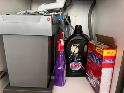 a shelf with two bottles of cleaner and a box at Miramar Front Beach Family Deluxe Studios No Swim Pool Access in Sunny Beach