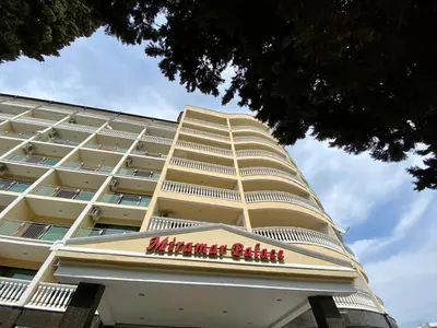 a large white building with a sign on it at Miramar Front Beach Family Deluxe Studios No Swim Pool Access in Sunny Beach