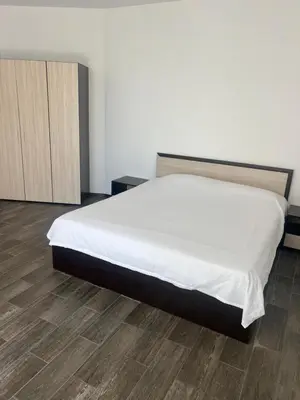 a bedroom with a white bed and a wooden floor at complex Sol Marine sunny beach in Sunny Beach