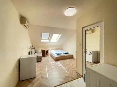 a bedroom with a bed in a room at Cozy Studio in Varna City