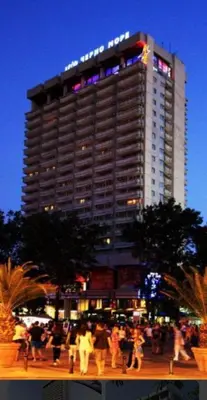 a tall building with people walking in front of it at Cozy Studio in Varna City