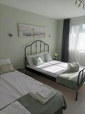 a bedroom with two beds and a window at Apartment Maria Luisa in Burgas City