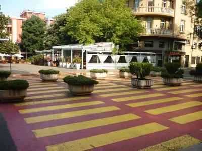 a courtyard with potted plants and a building at Sea Garden Plaza Apartment - Free Parking in Burgas City