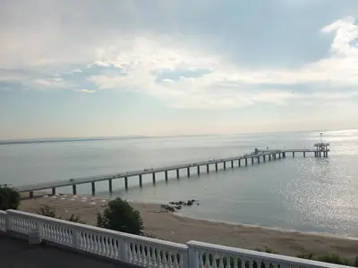a pier in the water next to a beach at Sea Garden Plaza Apartment - Free Parking in Burgas City