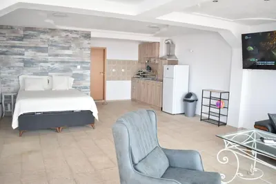a living room with a bed and a kitchen at Вlue horizon in Sveti Vlas