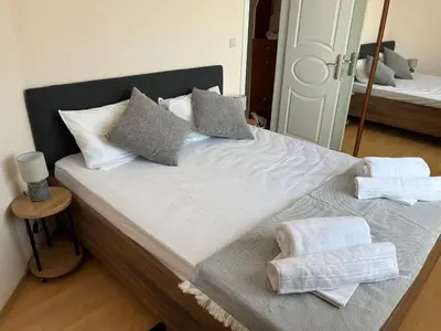 a bedroom with a bed with towels on it at Сарафово холидейс in Burgas City