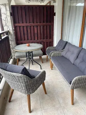 a balcony with a couch and chairs and a table at Amphora studio 209 in Sveti Vlas